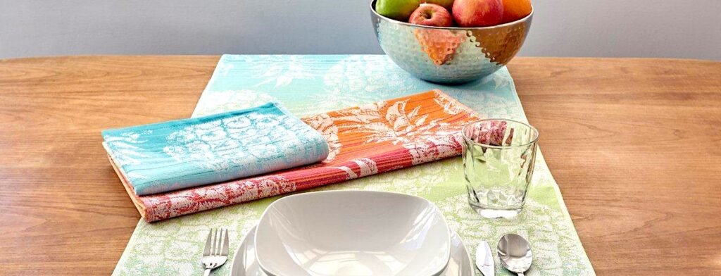 Colorful cotton jacquard towels and runner on doing table with a blow of fruit